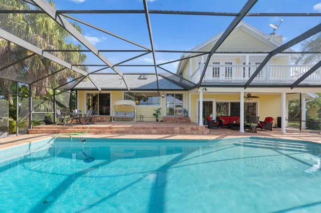 a view of a house with backyard porch and sitting area