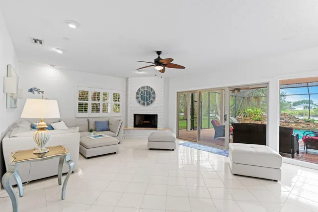 a bedroom with a bed a chandelier and a window