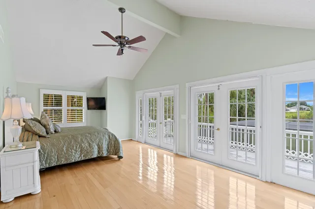 a bedroom with a large bed and a window