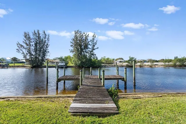 an aerial view of a house with swimming pool and garden