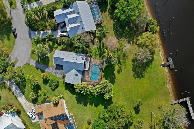 an aerial view of a house with a yard