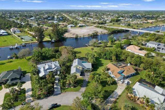 an aerial view of lake and residential houses with outdoor space