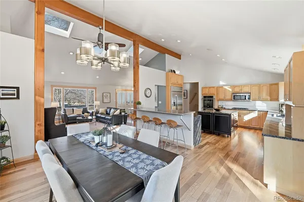 a living room with lots of furniture and kitchen view