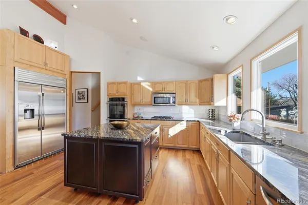 a kitchen with granite countertop a stove and refrigerator