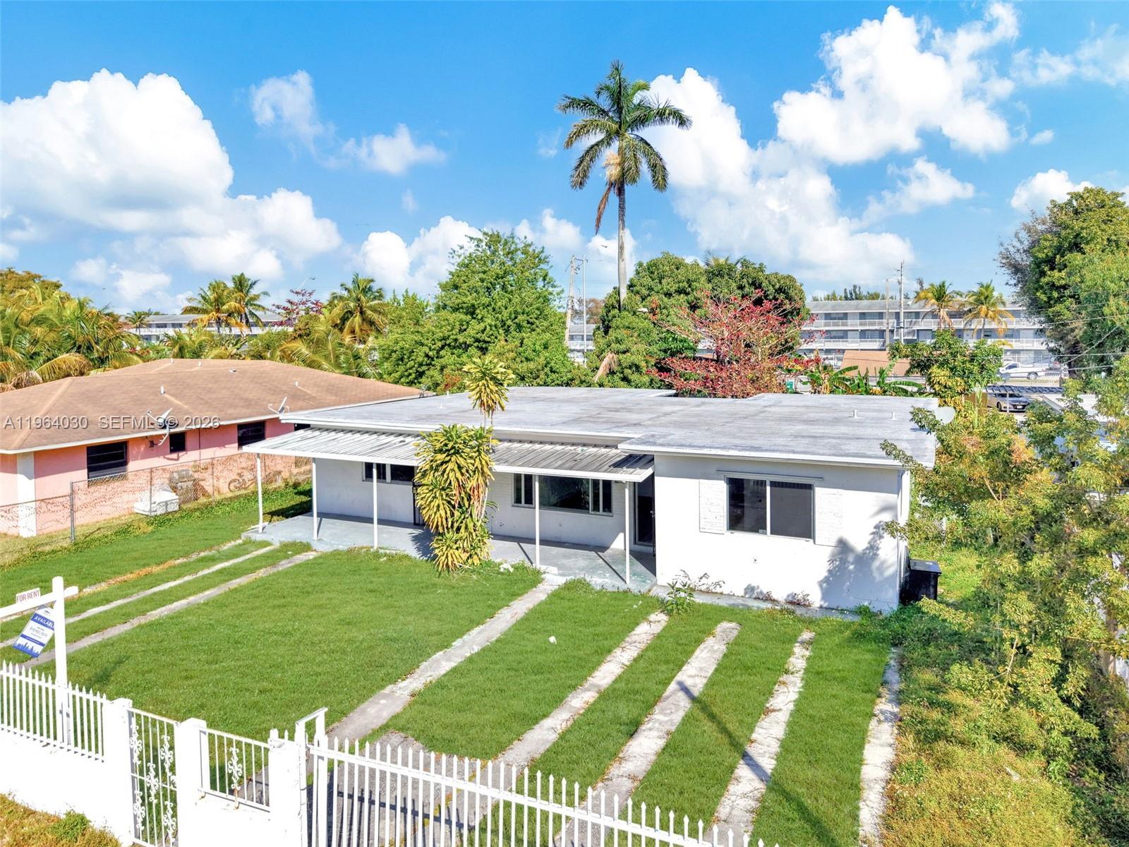 1391 Northwest 102nd Street, Unit 1391 Miami, FL 33147 - Photo 12 of 32 a front view of a house with garden