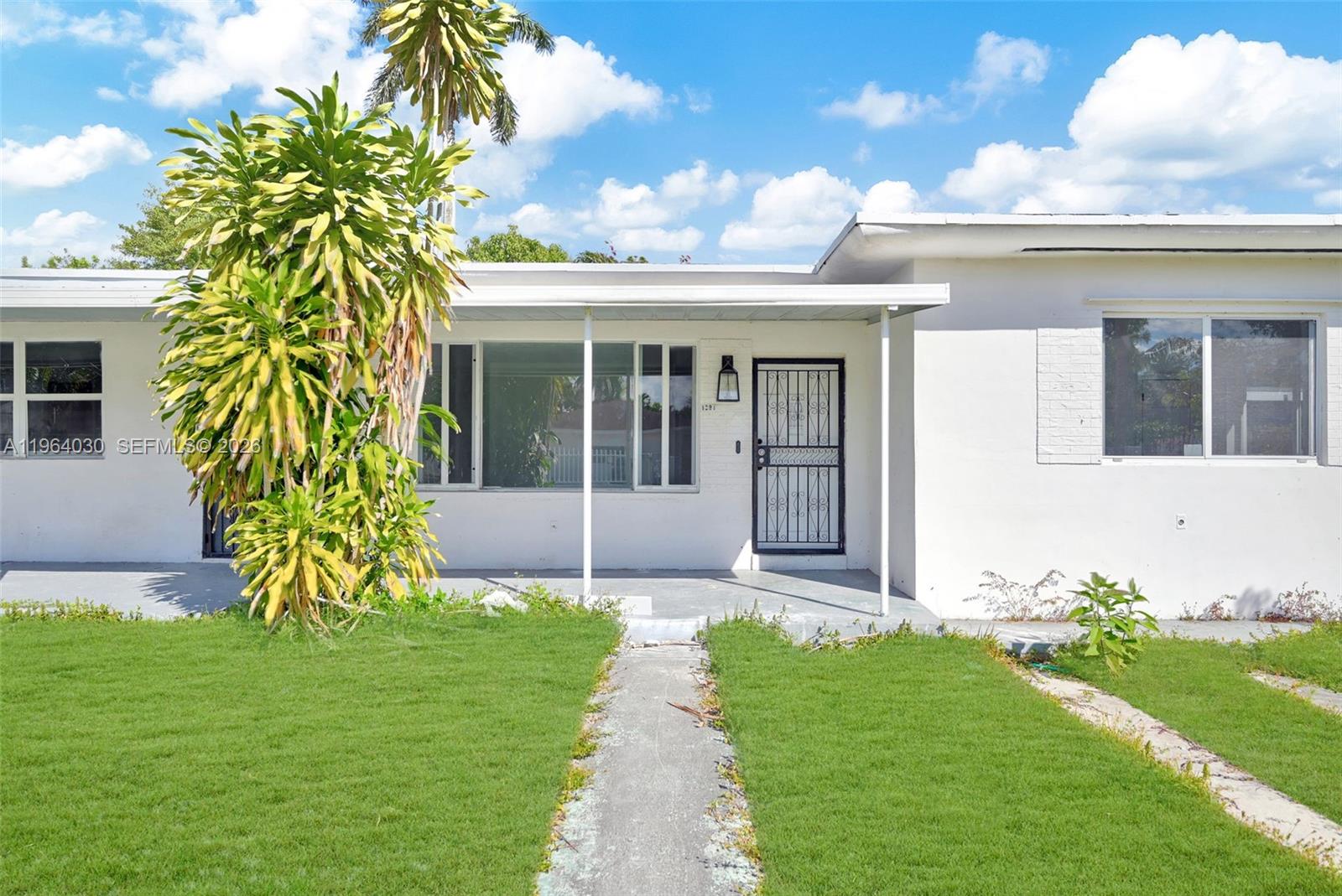 1391 Northwest 102nd Street, Unit 1391 Miami, FL 33147 - Photo 14 of 32 a front view of a house with garden