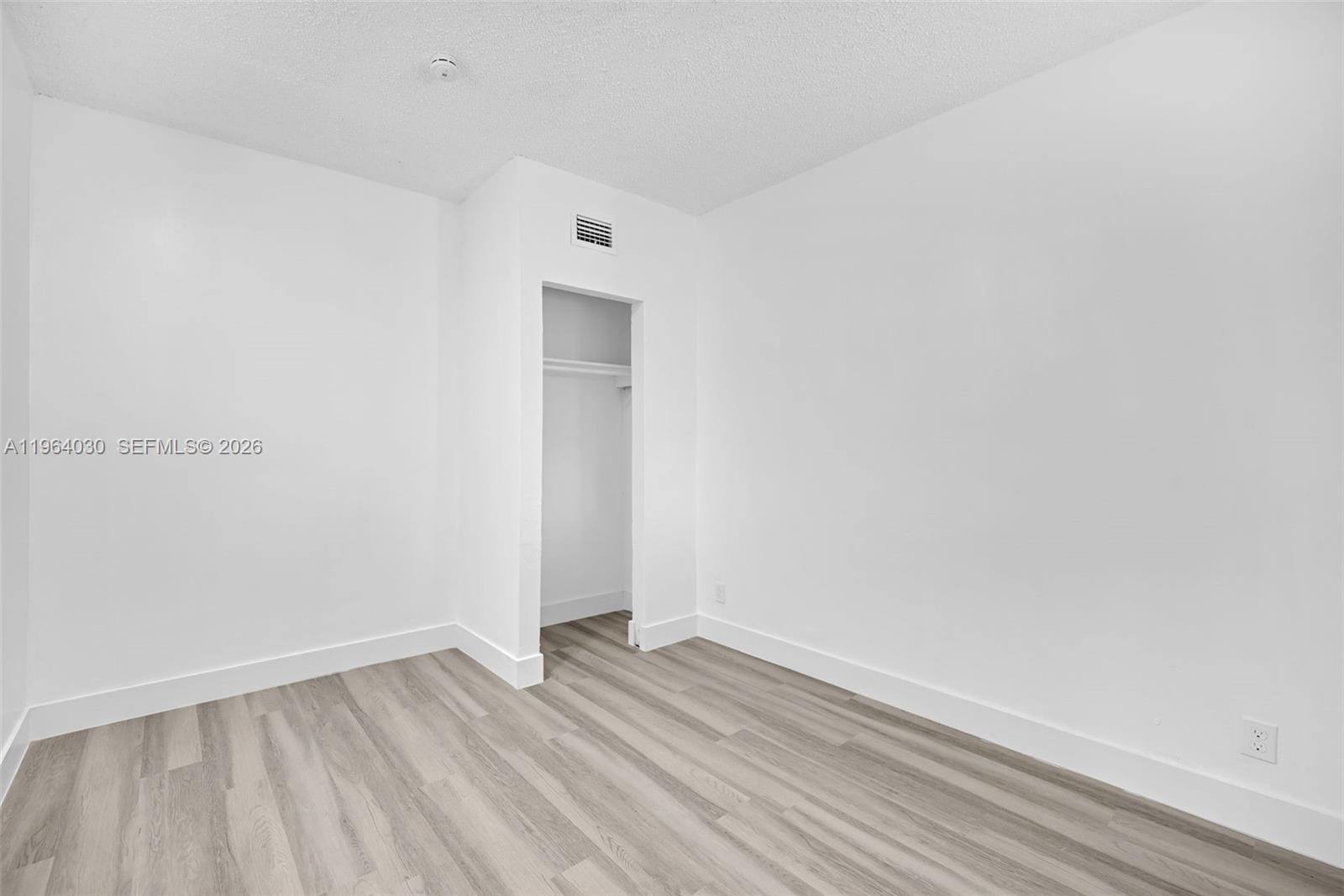 1391 Northwest 102nd Street, Unit 1391 Miami, FL 33147 - Photo 21 of 32 a view of an empty room with wooden floor