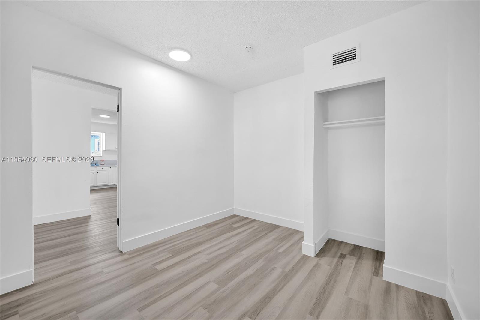 1391 Northwest 102nd Street, Unit 1391 Miami, FL 33147 - Photo 22 of 32 wooden floor in an empty room