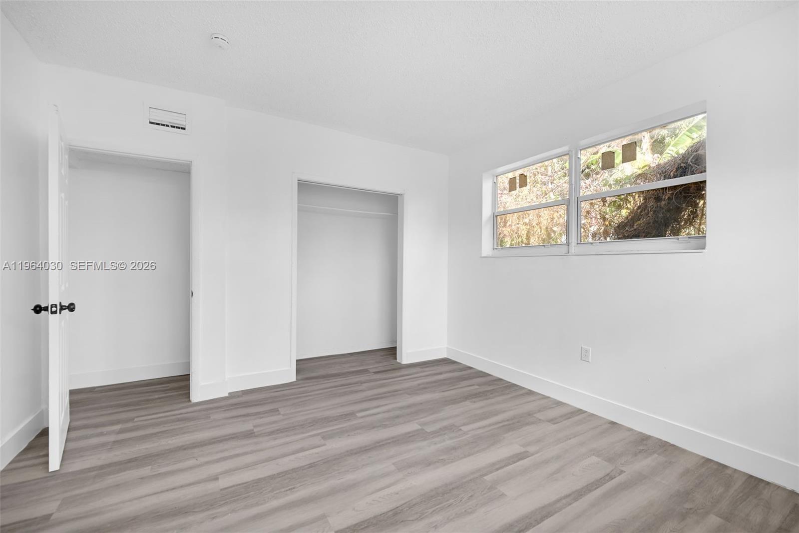 1391 Northwest 102nd Street, Unit 1391 Miami, FL 33147 - Photo 25 of 32 a view of empty room with wooden floor