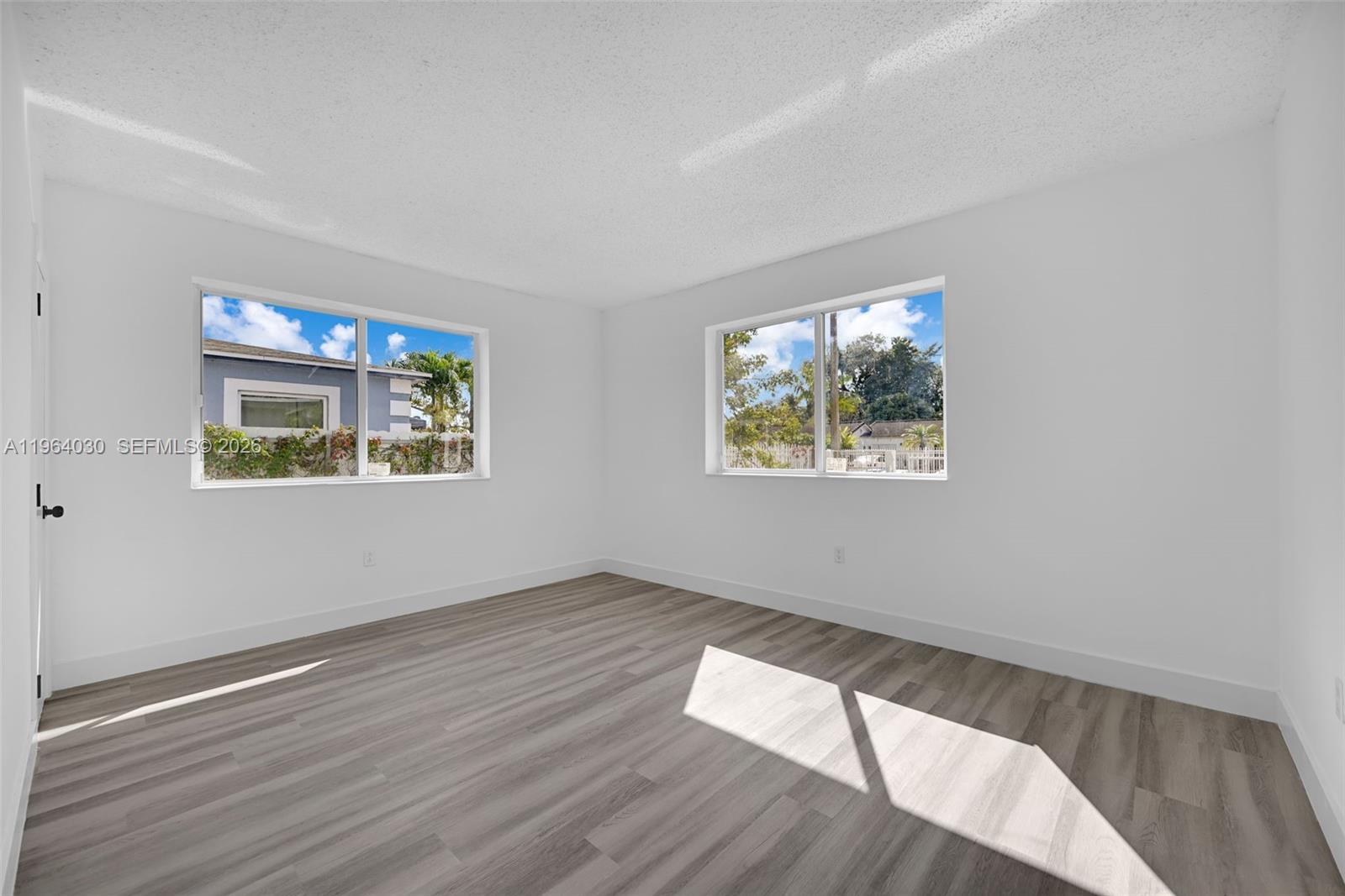 1391 Northwest 102nd Street, Unit 1391 Miami, FL 33147 - Photo 27 of 32 wooden floor in an empty room with a window