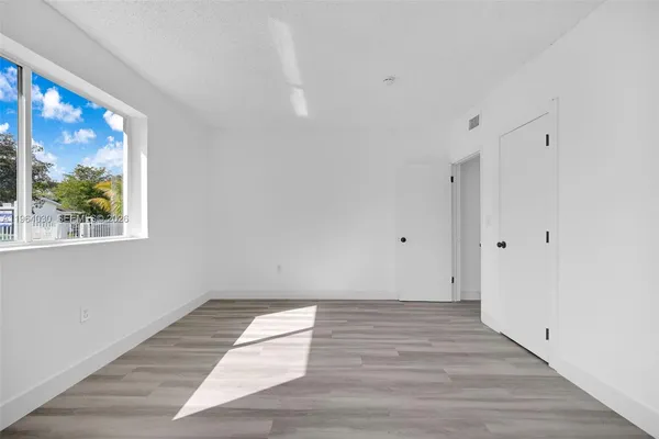 a view of a room with wooden floor