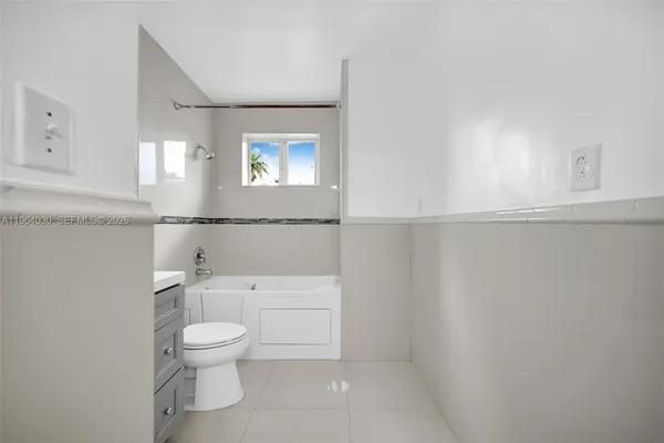 a white toilet sitting next to a bathroom sink