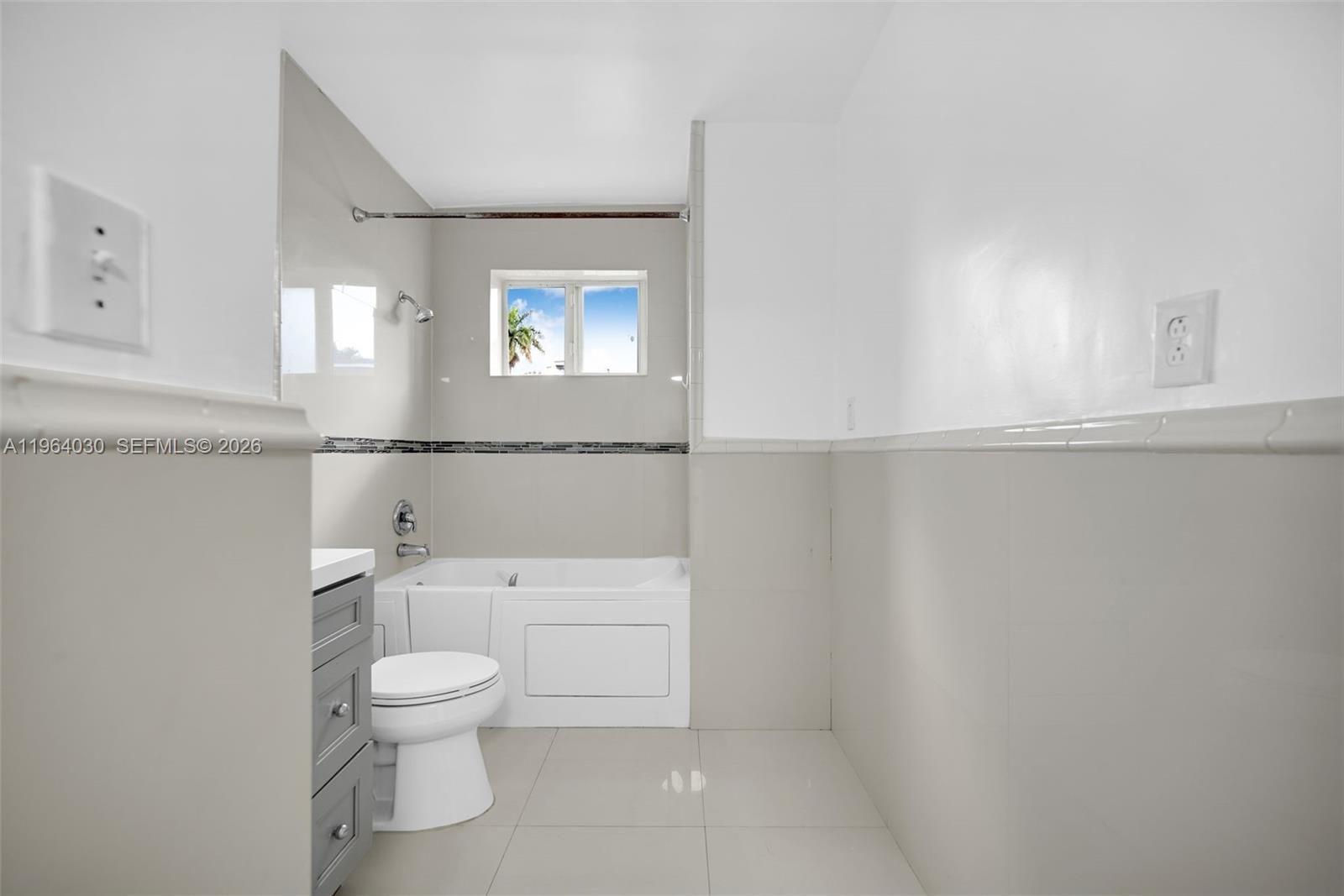 1391 Northwest 102nd Street, Unit 1391 Miami, FL 33147 - Photo 6 of 32 a white toilet sitting next to a bathroom sink