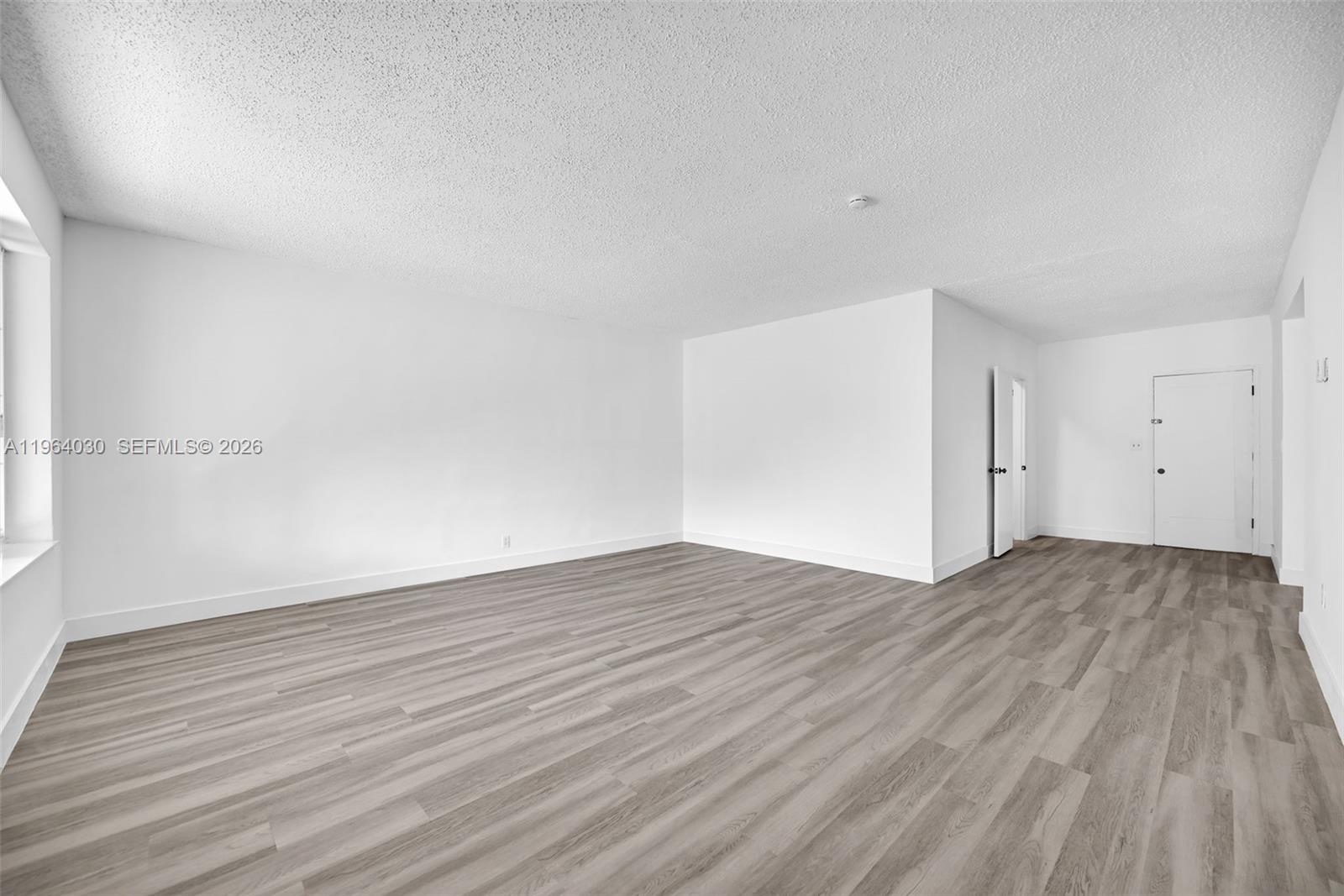 1391 Northwest 102nd Street, Unit 1391 Miami, FL 33147 - Photo 10 of 32 a view of empty room with wooden floor and fan
