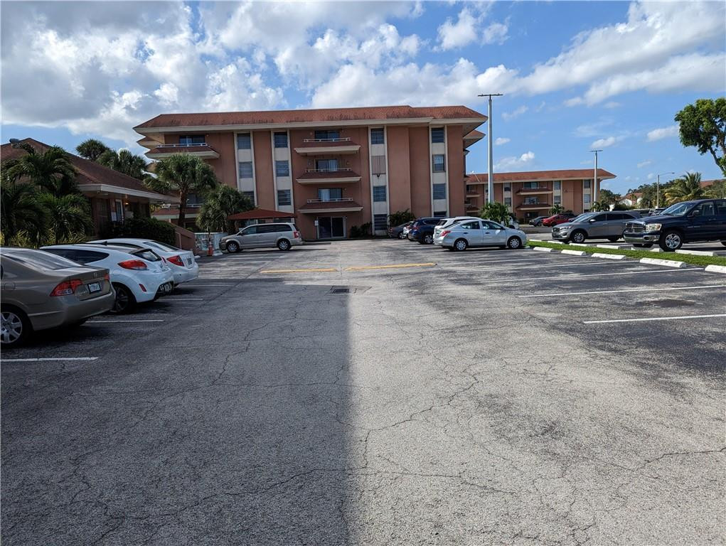 17530 Northwest 68th Avenue, Unit C4006 Hialeah, FL 33015 - Photo 2 of 5 a view of street with parked cars