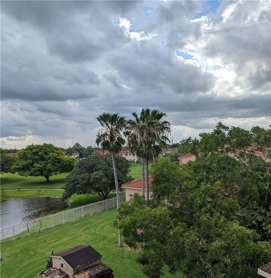 17530 Northwest 68th Avenue, Unit C4006 Hialeah, FL 33015 - Photo 3 of 5 a picture of a yard with plants and large trees