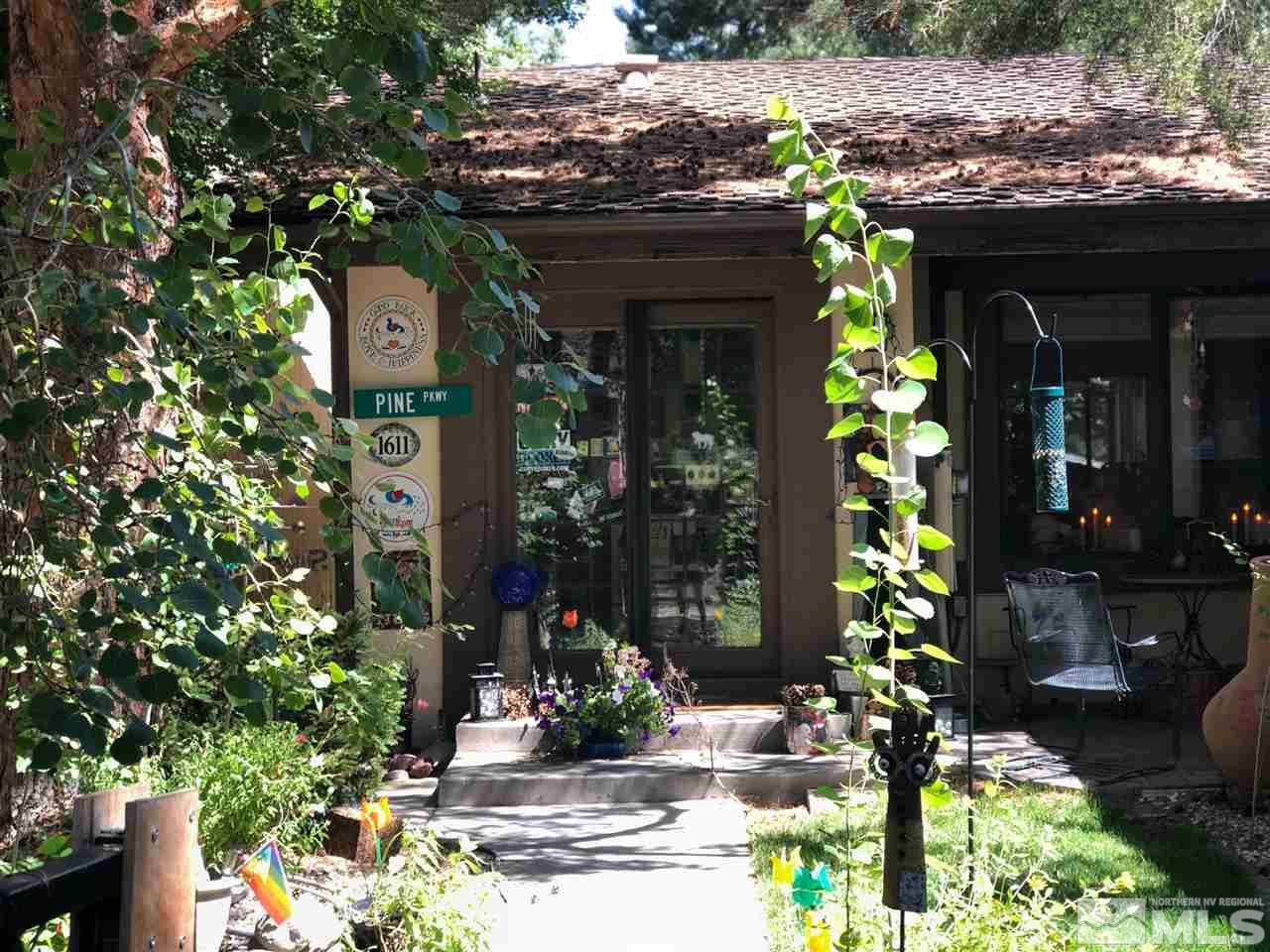 1611 Foster Drive Reno, NV 89509 - Photo 1 of 35 a front view of a house with a yard and potted plants