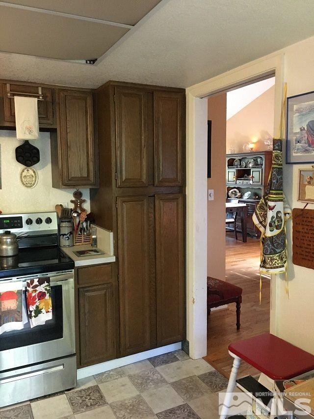 1611 Foster Drive Reno, NV 89509 - Photo 18 of 35 a kitchen with stainless steel appliances granite countertop a refrigerator and a stove top oven