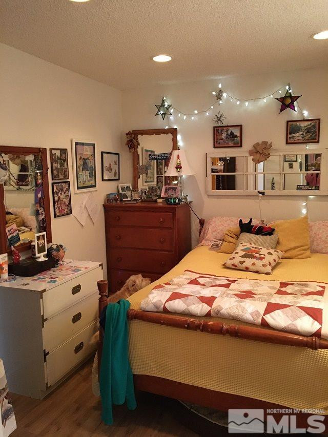 1611 Foster Drive Reno, NV 89509 - Photo 22 of 35 a bed room with a bed mirror and furniture