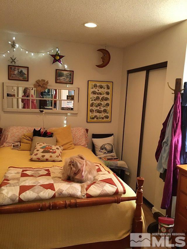 1611 Foster Drive Reno, NV 89509 - Photo 23 of 35 a bedroom with a bed and a mirror
