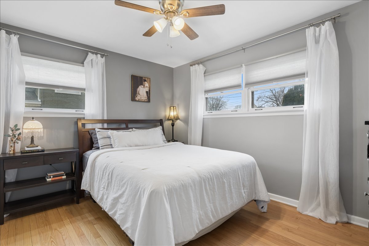 504 North Russel Street Mount Prospect, IL 60056 - Photo 11 of 19 a bedroom with a bed and a chandelier