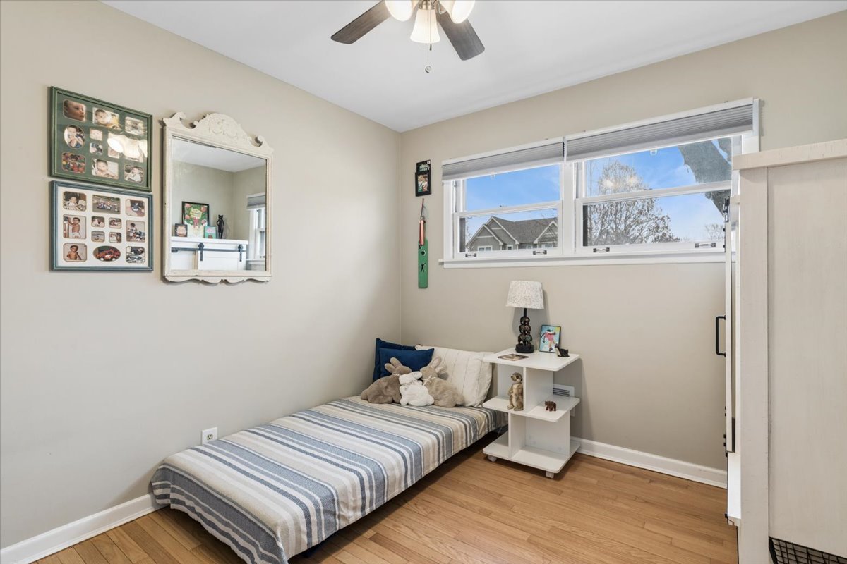 504 North Russel Street Mount Prospect, IL 60056 - Photo 13 of 19 a bedroom with a bed and a painting on the wall