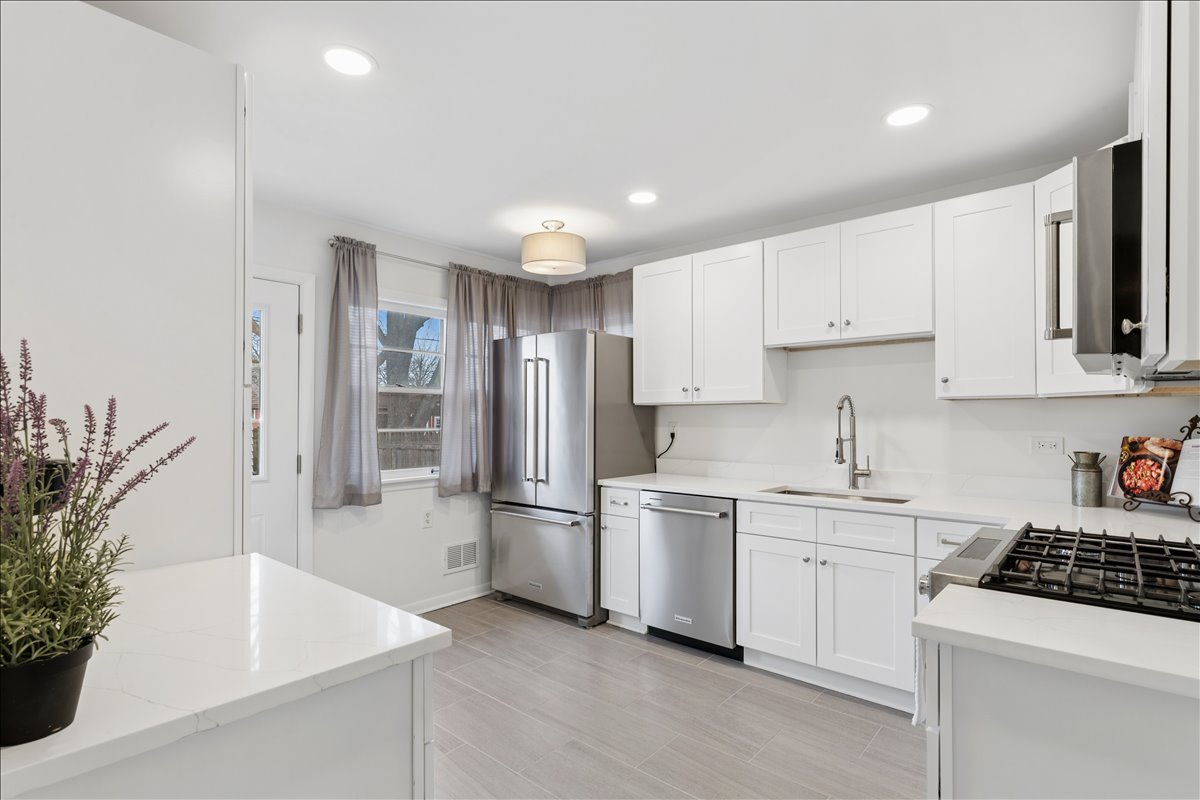 504 North Russel Street Mount Prospect, IL 60056 - Photo 6 of 19 a kitchen with white cabinets and refrigerator