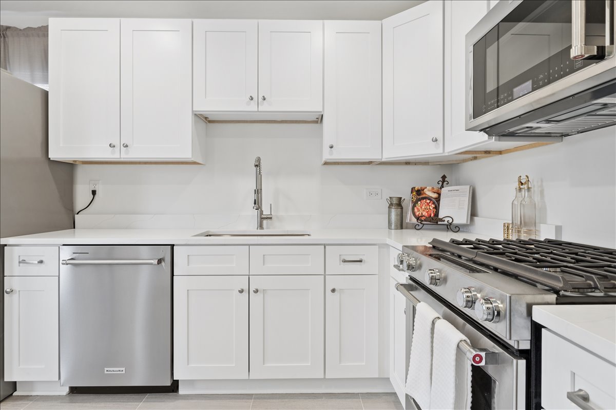504 North Russel Street Mount Prospect, IL 60056 - Photo 7 of 19 a kitchen with white cabinets and appliances