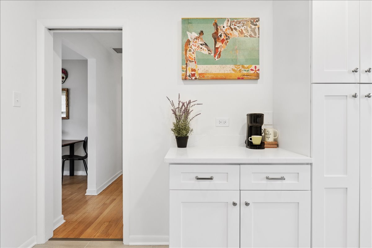 504 North Russel Street Mount Prospect, IL 60056 - Photo 9 of 19 a kitchen with a sink and a painting on the wall