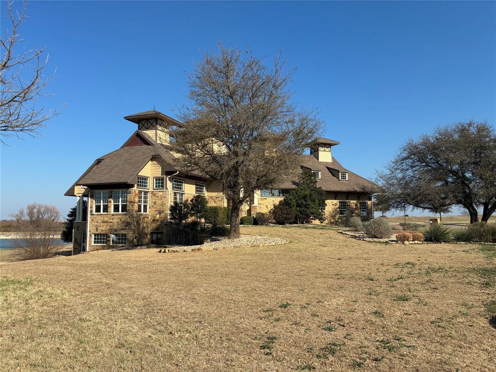 6500 Castle Royle Drive Cleburne, TX 76033 - Photo 21 of 29 a front view of a house with a yard covered in snow