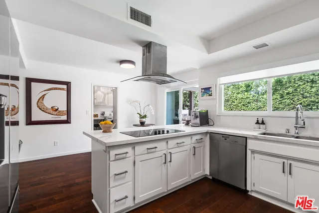 a kitchen with a sink window and cabinets