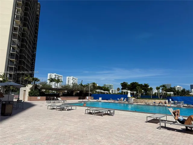 a view of swimming pool with outdoor seating and city view