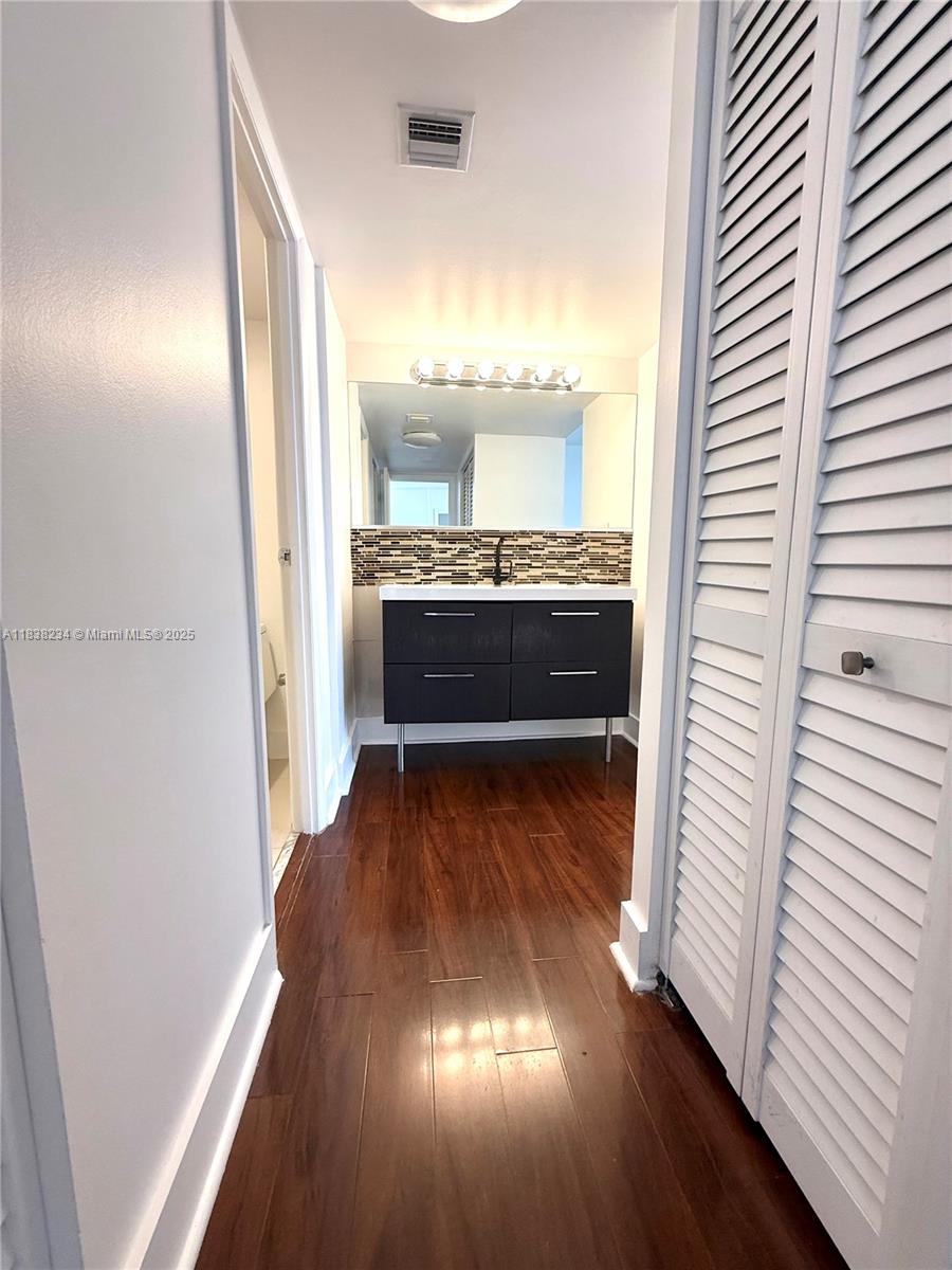 20335 West Country Club Drive, Unit 502 Aventura, FL 33180 - Photo 21 of 26 a view of kitchen and hall with wooden floor