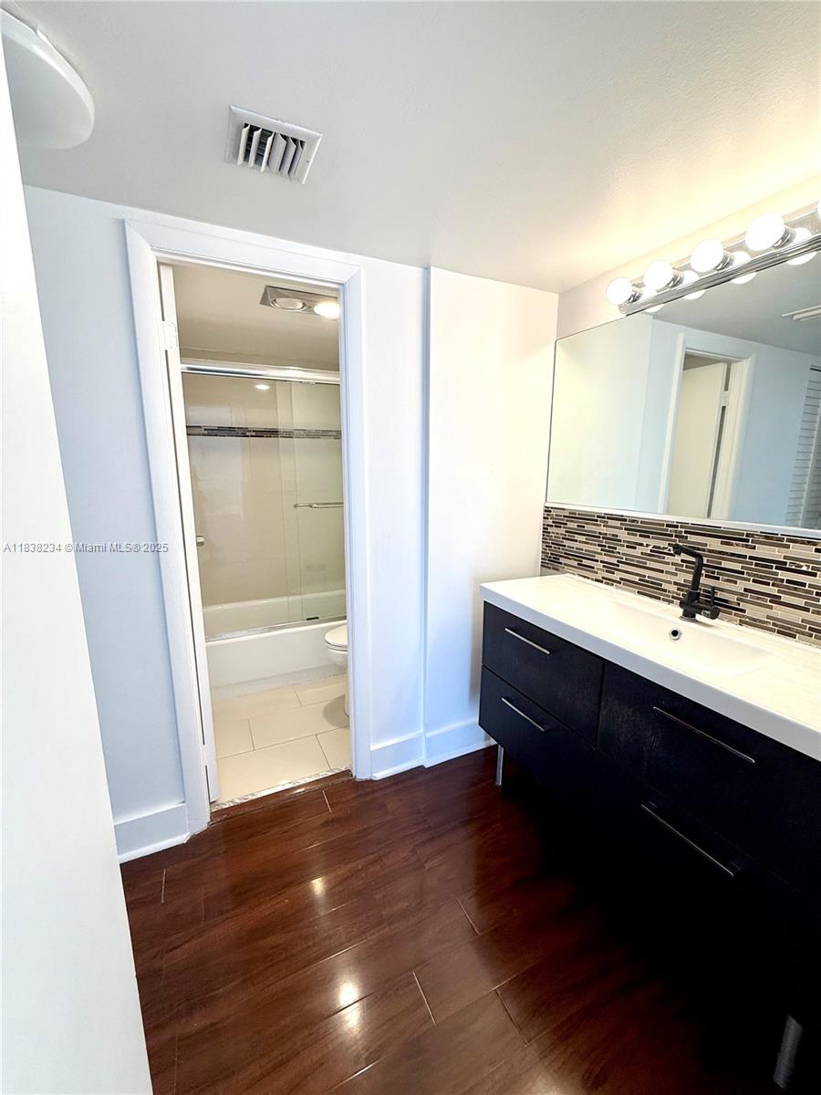 20335 West Country Club Drive, Unit 502 Aventura, FL 33180 - Photo 22 of 26 a bathroom with a sink and a mirror