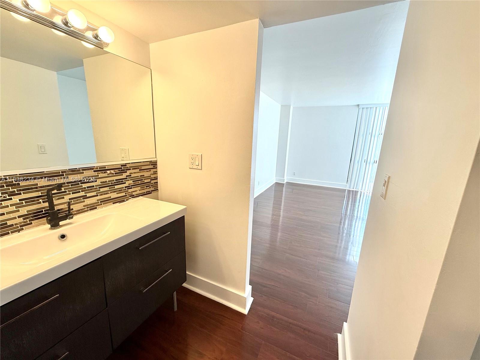 20335 West Country Club Drive, Unit 502 Aventura, FL 33180 - Photo 24 of 26 a bathroom with a sink and a mirror