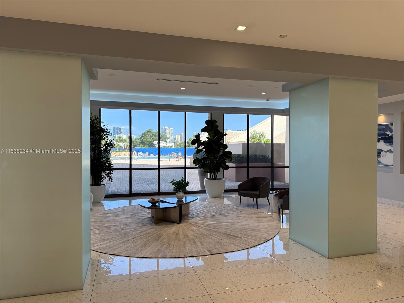 20335 West Country Club Drive, Unit 502 Aventura, FL 33180 - Photo 3 of 26 a view of a living room and a floor to ceiling window