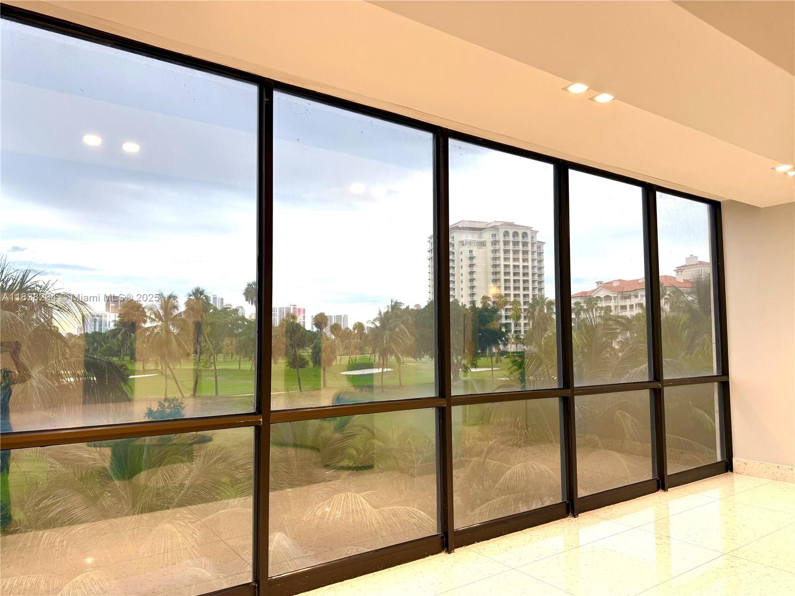 20335 West Country Club Drive, Unit 502 Aventura, FL 33180 - Photo 5 of 26 a view of a glass door with a floor to ceiling window