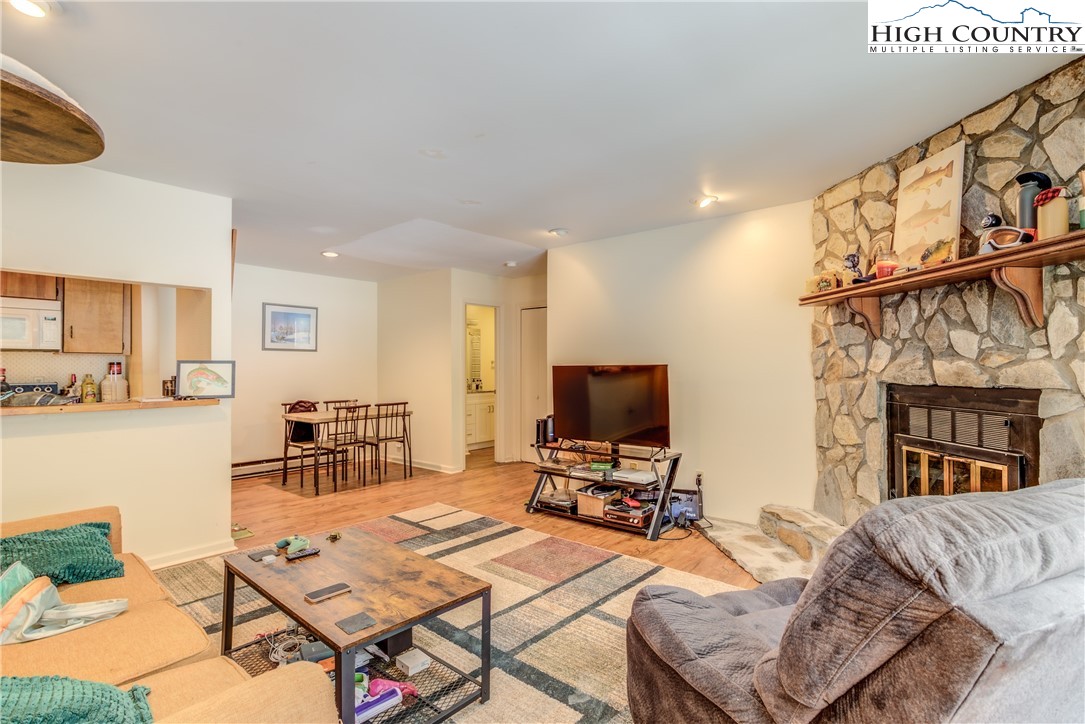 200 Pilgrims Way, Unit 24 Boone, NC 28607 - Photo 3 of 15 a living room with furniture a flat screen tv and a fireplace