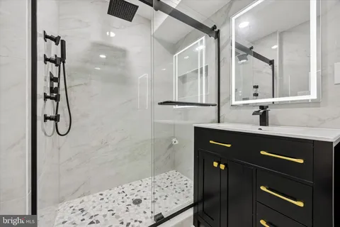 a bathroom with a toilet sink and a mirror