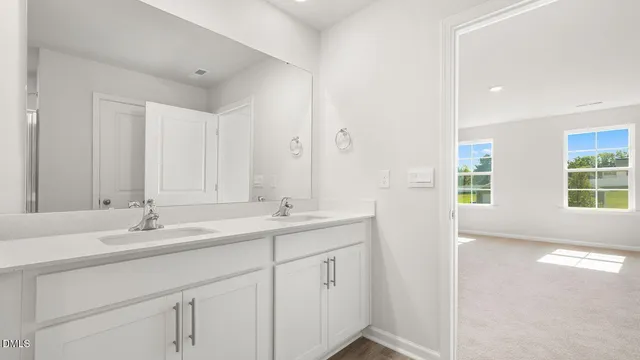 a bathroom with 2 sink tub and a mirror