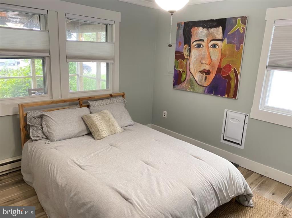 13803 Fountain Road Ocean City, MD 21842 - Photo 12 of 23 a bedroom with a bed and wall painting