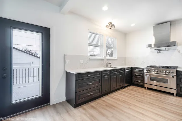 a kitchen with stainless steel appliances granite countertop a stove and a sink