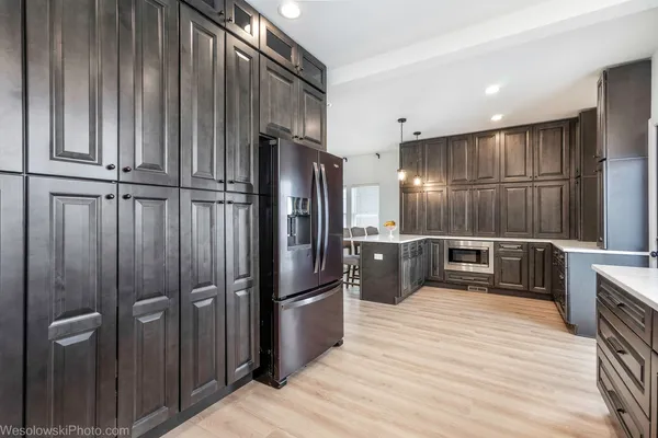 a kitchen with kitchen island a counter top space stainless steel appliances and cabinets