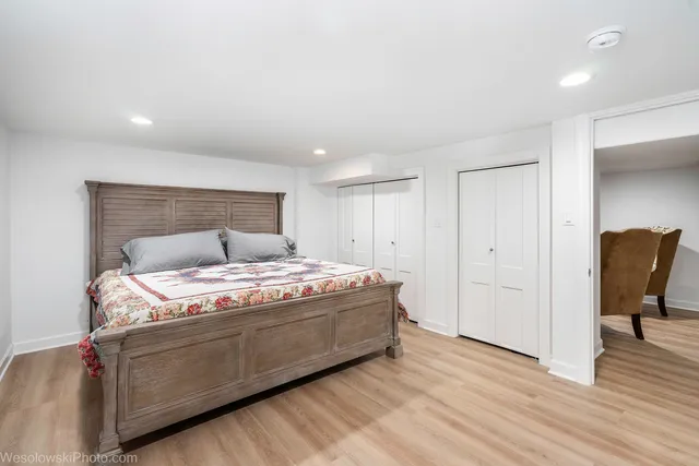 a bedroom with a bed and a chair