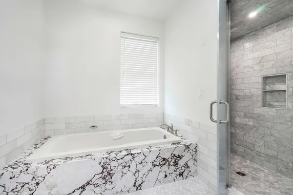 a bathroom with a bath tub and shower