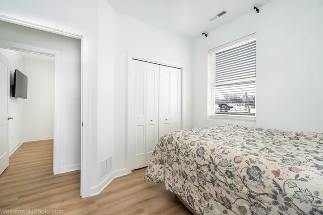 a bedroom with a bed and a window