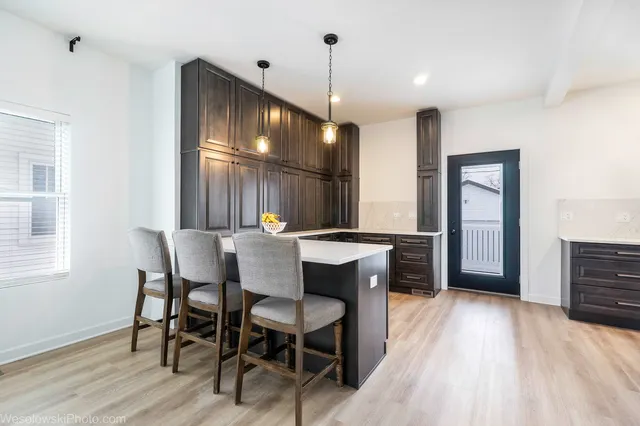 a view of a a dining room with furniture window and wooden floor