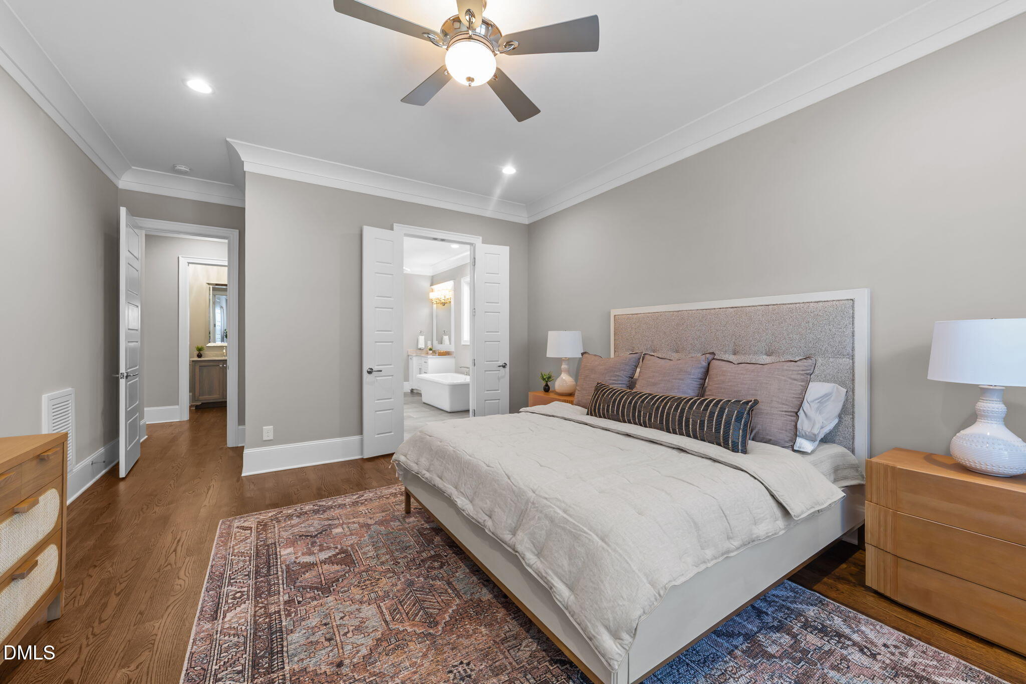 2600 Oxford Road Raleigh, NC 27608 - Photo 23 of 42 a bedroom with a large bed and a chandelier