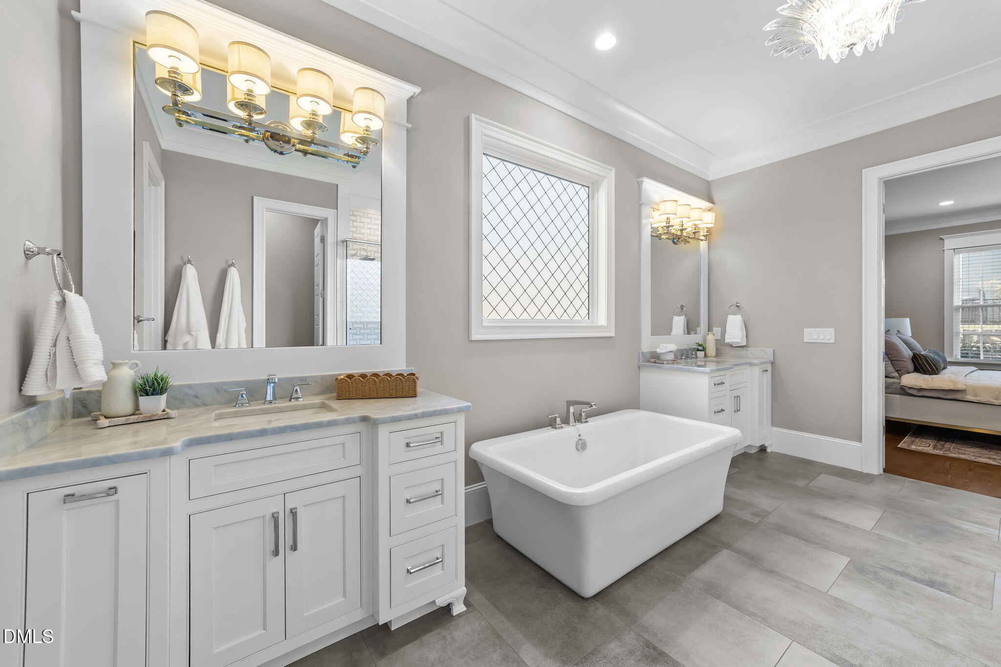 2600 Oxford Road Raleigh, NC 27608 - Photo 24 of 42 a spacious bathroom with a double vanity sink a mirror a bathtub and next to a window