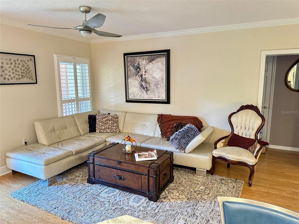 8911 Blind Pass Road, Unit 220 St. Pete Beach, FL 33706 - Photo 32 of 67 a living room with furniture and wooden floor